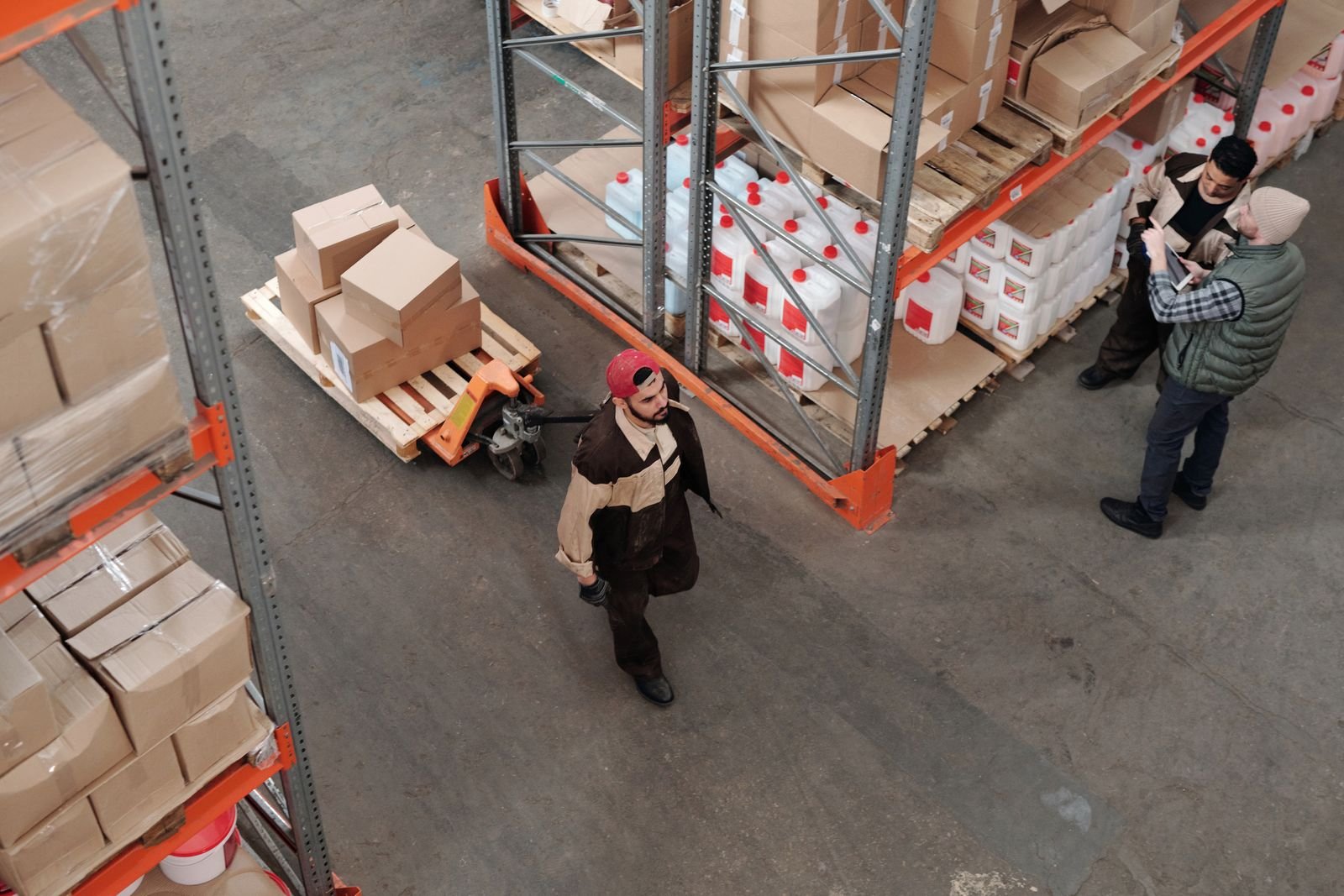 Palletized freight being moved by pallet jack in a warehouse